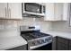 Stainless steel gas range and microwave in a newly remodeled kitchen at 2541 Showcase Dr, Las Vegas, NV 89134