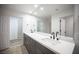 Elegant bathroom boasts double sinks, a large mirror, and access to a walk-in closet at 2541 Showcase Dr, Las Vegas, NV 89134