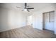 Bright bedroom with ceiling fan, large closet, and wood-look flooring at 2541 Showcase Dr, Las Vegas, NV 89134