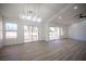 Elegant dining room with a stylish light fixture and sliding glass doors leading to the patio at 2541 Showcase Dr, Las Vegas, NV 89134