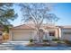 Single-story home with tan exterior, tile roof, and landscaped yard at 2541 Showcase Dr, Las Vegas, NV 89134