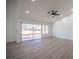 Bright and spacious living room with large sliding glass doors and wood-look flooring at 2541 Showcase Dr, Las Vegas, NV 89134