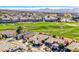 Aerial view showcasing a house on a golf course with mountain backdrop at 2589 Sumter St, Henderson, NV 89052