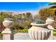 Landscaped backyard with mountain views and decorative urns at 2589 Sumter St, Henderson, NV 89052