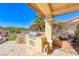 Outdoor kitchen with built-in grill and seating area at 2589 Sumter St, Henderson, NV 89052