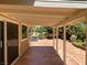 Covered patio with terracotta tile flooring and lush landscaping at 2908 Channel Bay Dr, Las Vegas, NV 89128