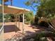 Backyard patio with covered seating area and fire pit at 2908 Channel Bay Dr, Las Vegas, NV 89128