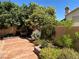 Landscaped backyard with a flagstone patio and fountain at 2908 Channel Bay Dr, Las Vegas, NV 89128