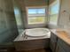 Elegant bathroom with soaking tub, walk-in shower, and dual sinks at 2908 Channel Bay Dr, Las Vegas, NV 89128