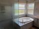 Elegant bathroom with soaking tub, walk-in shower, and dual sinks at 2908 Channel Bay Dr, Las Vegas, NV 89128