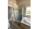 Bathroom with a walk-in shower and a soaking tub at 2908 Channel Bay Dr, Las Vegas, NV 89128