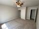 Cozy bedroom with ceiling fan, closet, and carpeted floor at 2908 Channel Bay Dr, Las Vegas, NV 89128