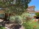 Tan two-story house with tile roof, mature landscaping, and a three-car garage at 2908 Channel Bay Dr, Las Vegas, NV 89128