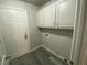 Bright laundry room with white cabinets and vinyl flooring at 2908 Channel Bay Dr, Las Vegas, NV 89128