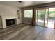 Bright living room with fireplace and sliding glass door leading to backyard at 2908 Channel Bay Dr, Las Vegas, NV 89128