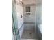 Large walk-in shower with tiled walls and built-in shelves at 2908 Channel Bay Dr, Las Vegas, NV 89128