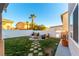 Landscaped backyard with fire pit and seating area at 2924 Rain Lily Ct, Las Vegas, NV 89117