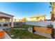 Landscaped backyard with pool, patio, and fire pit at 2924 Rain Lily Ct, Las Vegas, NV 89117