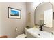 Modern bathroom with gray vanity, arched mirror, and updated fixtures at 2924 Rain Lily Ct, Las Vegas, NV 89117