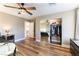 Bright bedroom with wood floors, mirrored closet, and ceiling fan at 2924 Rain Lily Ct, Las Vegas, NV 89117