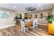 Open concept dining room with a large wooden table and view of the kitchen at 2924 Rain Lily Ct, Las Vegas, NV 89117