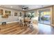 Bright dining room features a wood table with white chairs and access to the backyard at 2924 Rain Lily Ct, Las Vegas, NV 89117