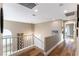 Upstairs hallway with hardwood floors and access to bedrooms at 2924 Rain Lily Ct, Las Vegas, NV 89117