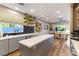 Modern kitchen with gray cabinets, a large island, and a hexagon tile backsplash at 2924 Rain Lily Ct, Las Vegas, NV 89117