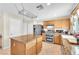 Kitchen with wood cabinets, granite countertops and stainless steel appliances at 3257 Aiken St, North Las Vegas, NV 89032