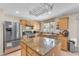 Kitchen with island, stainless steel appliances, and wood cabinets at 3257 Aiken St, North Las Vegas, NV 89032