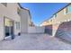 Empty backyard with gravel and privacy fence at 3844 Juanita May Ave, North Las Vegas, NV 89032