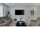 Living area featuring gray couches, a coffee table, and a TV at 3844 Juanita May Ave, North Las Vegas, NV 89032