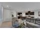 Living room with gray couches and a view of the kitchen at 3844 Juanita May Ave, North Las Vegas, NV 89032