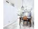 Dining area with glass-top table, six chairs, and modern lighting at 3905 Blairmoor St, North Las Vegas, NV 89032