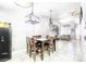 Dining area with wood table and chairs, modern light fixtures, and open floor plan at 3905 Blairmoor St, North Las Vegas, NV 89032