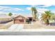 Single-story house with brown garage door, desert landscaping, and palm trees at 3905 Blairmoor St, North Las Vegas, NV 89032