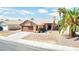 One-story house with brown garage door, desert landscaping, and palm trees at 3905 Blairmoor St, North Las Vegas, NV 89032