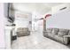 Living room with tiled floors, fireplace, and two gray couches at 3905 Blairmoor St, North Las Vegas, NV 89032