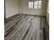 Bright living room features grey vinyl flooring and a large window at 4017 Danford Pl, Las Vegas, NV 89102