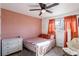 Relaxing bedroom with a full-size bed, peach walls, and comfortable seating at 4116 E Ogden Ave, Las Vegas, NV 89110