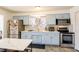 Updated kitchen with light blue cabinets and stainless steel appliances at 4116 E Ogden Ave, Las Vegas, NV 89110