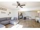 Bright living room with open floor plan, gray sectional sofa, and kitchen view at 4116 E Ogden Ave, Las Vegas, NV 89110