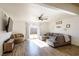 Spacious living room featuring a gray sectional sofa and backyard access at 4116 E Ogden Ave, Las Vegas, NV 89110