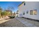 Backyard with a stone pathway and mature tree at 5236 Woodlawn Ln, Las Vegas, NV 89130