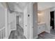 Modern bathroom with white cabinets and gray flooring at 5236 Woodlawn Ln, Las Vegas, NV 89130