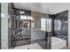 Elegant bathroom with frameless shower and marble tile at 5236 Woodlawn Ln, Las Vegas, NV 89130