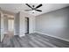 Well lit bedroom with ceiling fan, gray flooring and access to hallway at 5236 Woodlawn Ln, Las Vegas, NV 89130