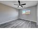 Spacious bedroom with gray walls, ceiling fan and gray flooring at 5236 Woodlawn Ln, Las Vegas, NV 89130