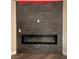 Modern electric fireplace with stone surround at 5236 Woodlawn Ln, Las Vegas, NV 89130