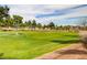 Expansive green golf course with trees and pathways at 5236 Woodlawn Ln, Las Vegas, NV 89130